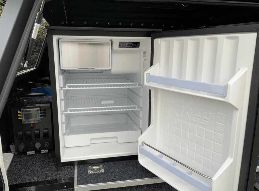 An upright 85L camper fridge installed in a 4WD canopy, ready to keep ingredients cool off-grid