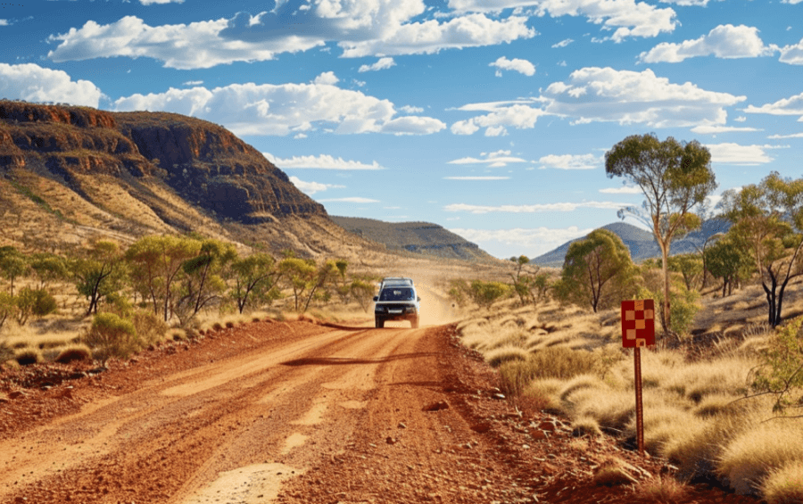 A 4WD camper on a formed gravel access road in Western Australia.