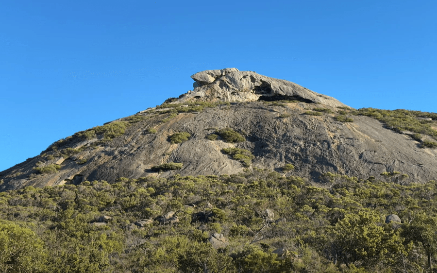 The granite slope and summit arch of Frenchman Peak.
