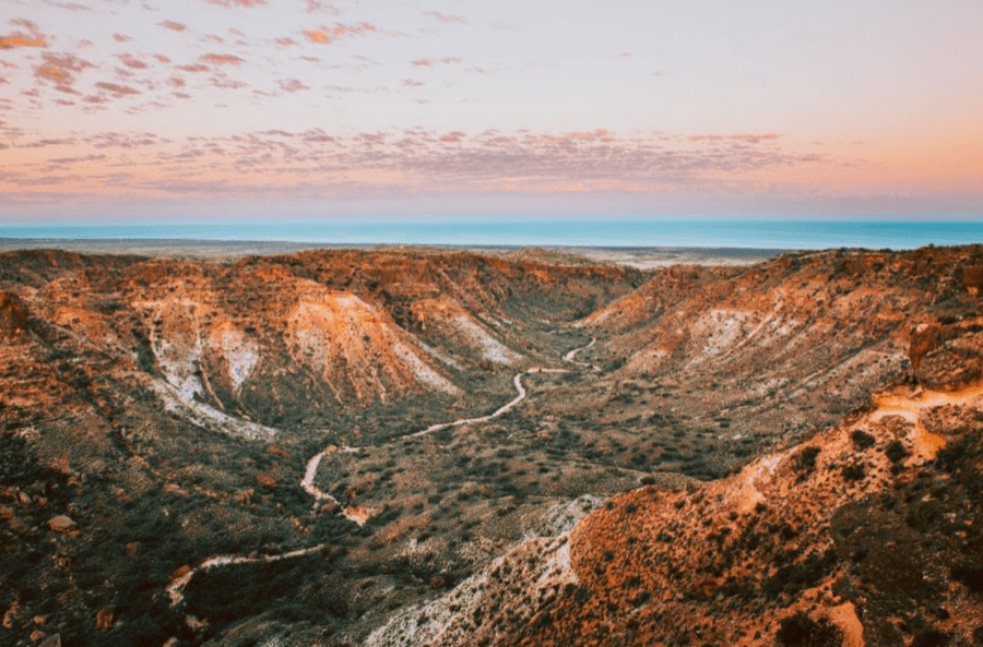 Aerial view of the Cape Range coastline meeting Ningaloo Reef.