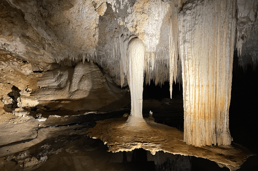 Limestone formations and quiet water inside a Margaret River region cave