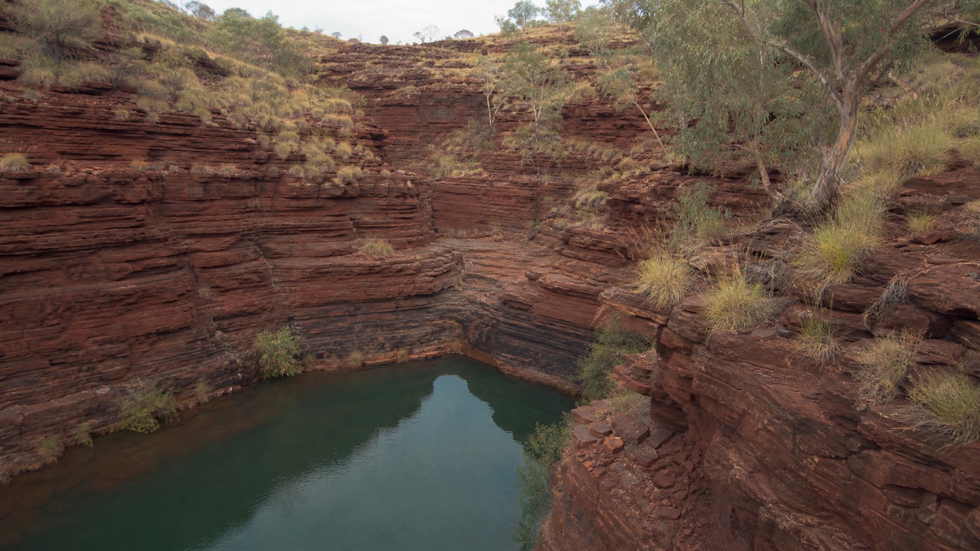 A banded-ironstone gorge and rock pool in Karijini National Park, Western Australia.