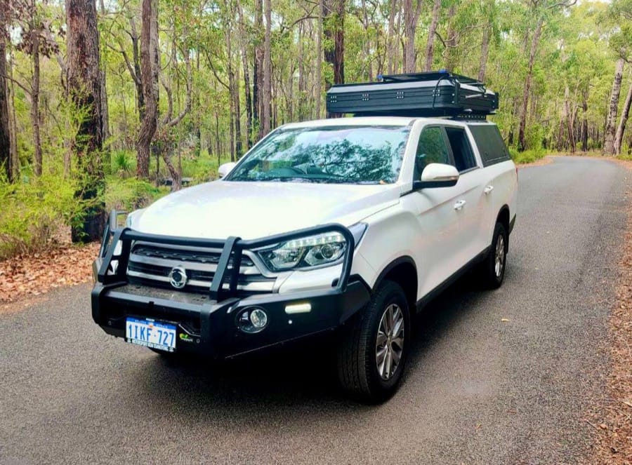 A Musso 4WD camper parked on a karri forest road in South West WA